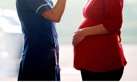 Women Giving Birth To A Baby Naturally In Hospital