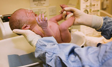 Women Giving Birth To A Baby Naturally In Hospital